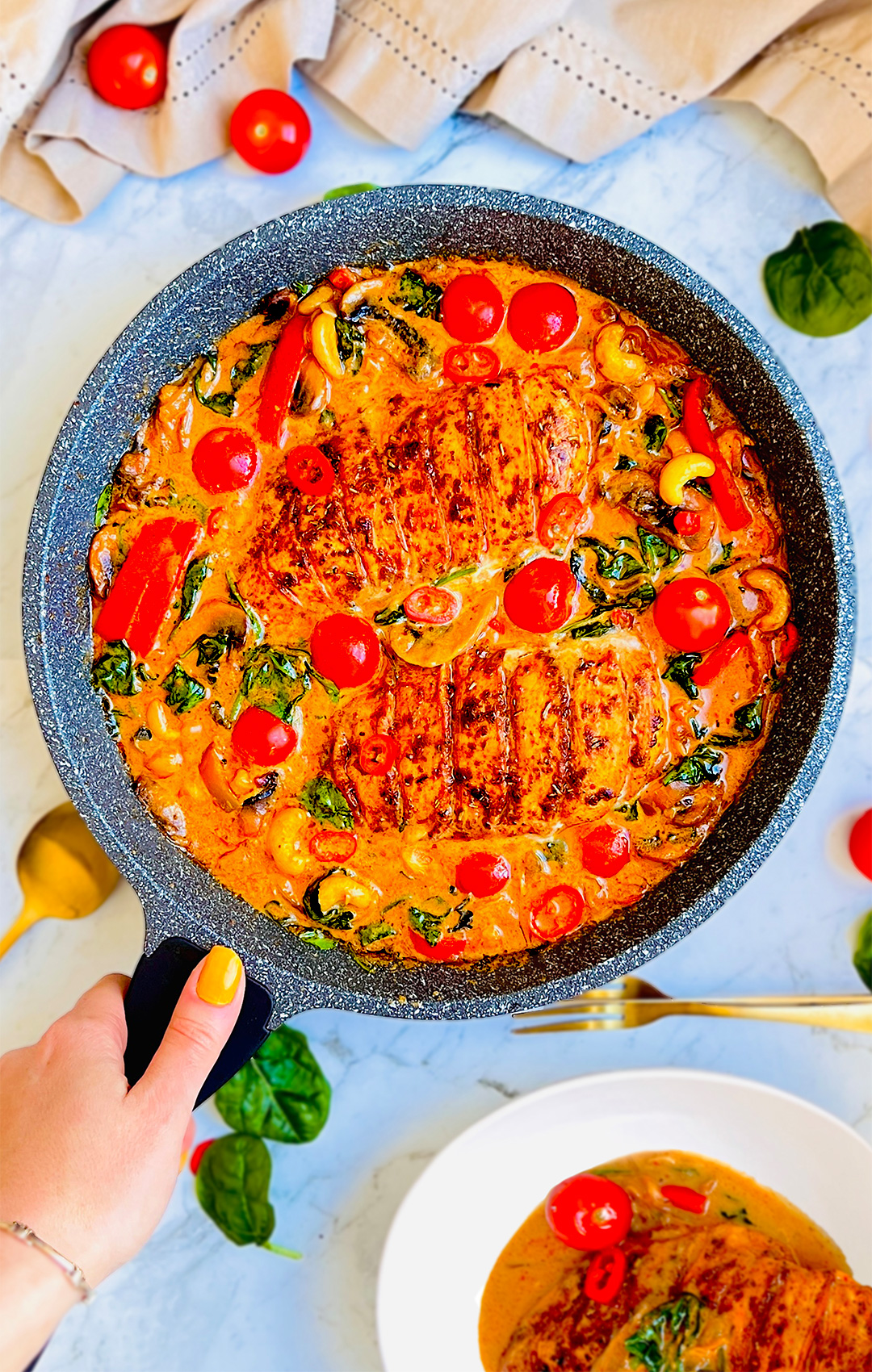 Creamy one-pan Tuscan chicken with spinach, cherry tomatoes, and cashews. Keto, gluten-free