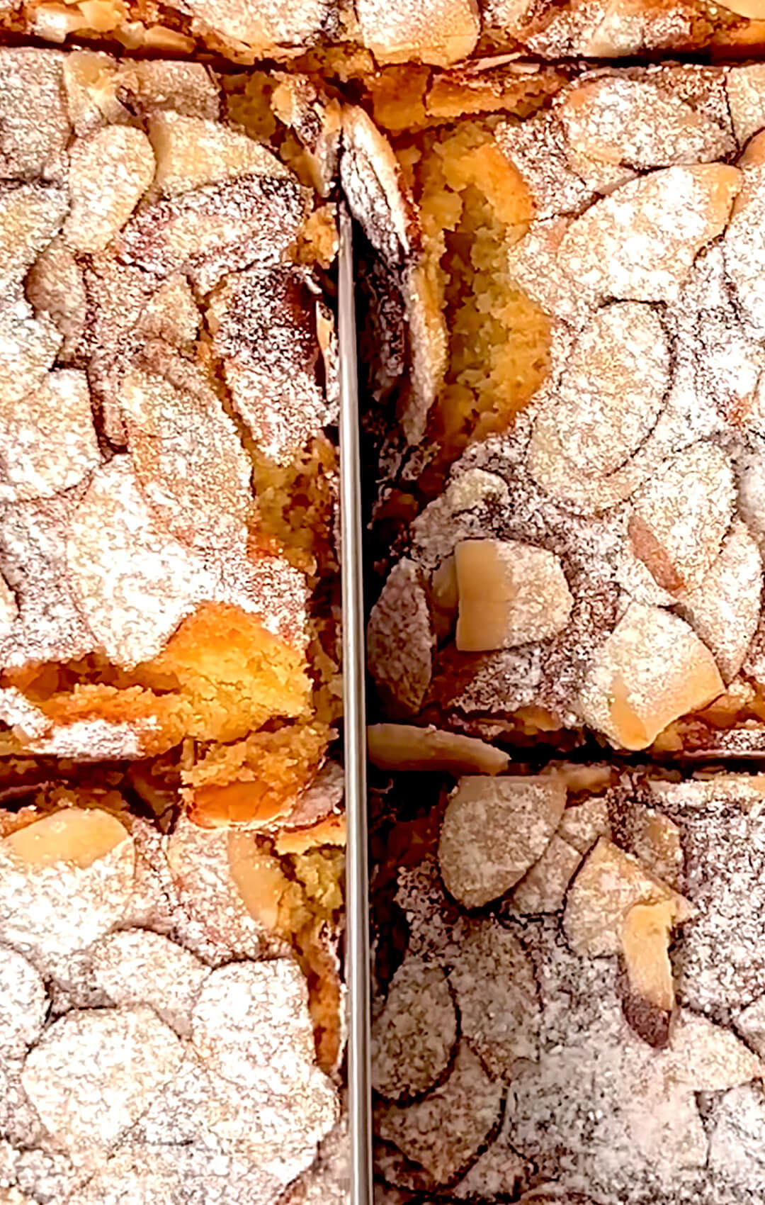 Second angle of the bars mid-slice, focusing on the delicate cracks in the almond topping and the rich, creamy frangipane layer beneath. Perfect sugar-free almond pastry , also Keto, paleo.
