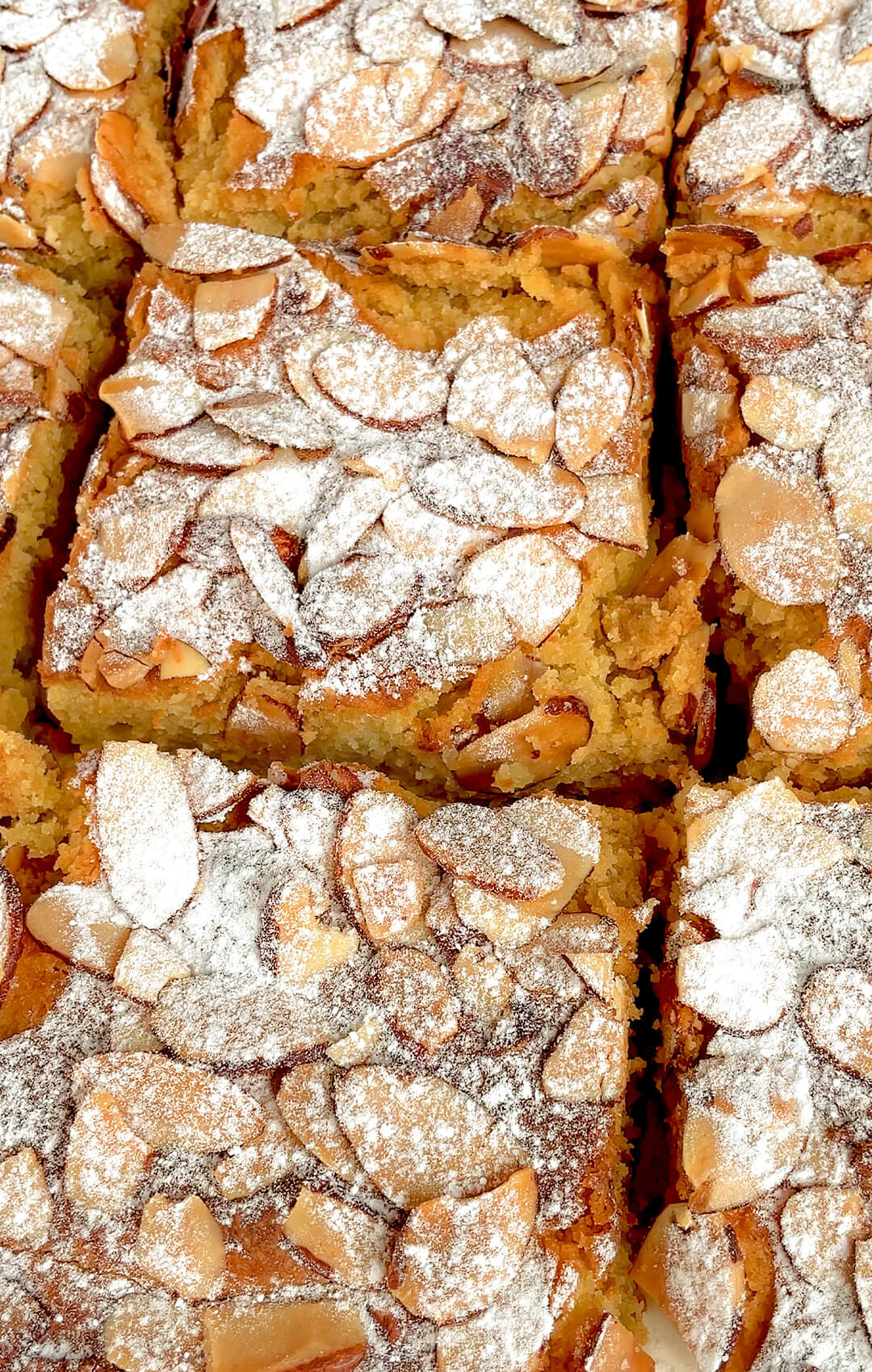 Side and top view of a sliced Almond Croissant Bar showing the golden, flaky topping with toasted almonds and a perfectly soft, creamy almond filling. Keto-friendly, Gluten-free, paleo and Dairy-Free option.