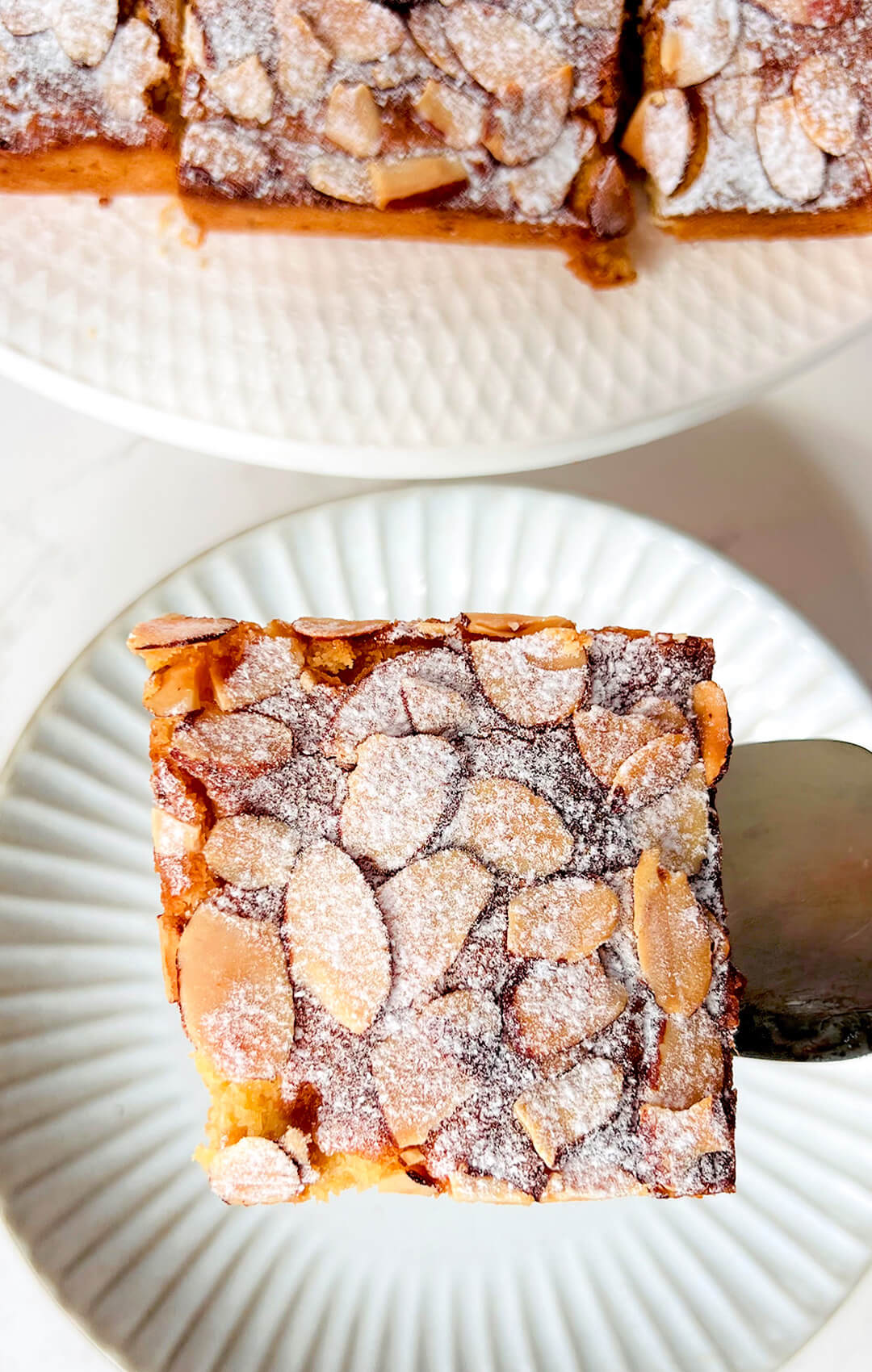 One sliced Almond Croissant Bar served on a plate, showing the glossy almond topping and soft, moist almond centre. Perfect for afternoon gatherings, sugar-free and grain-free.