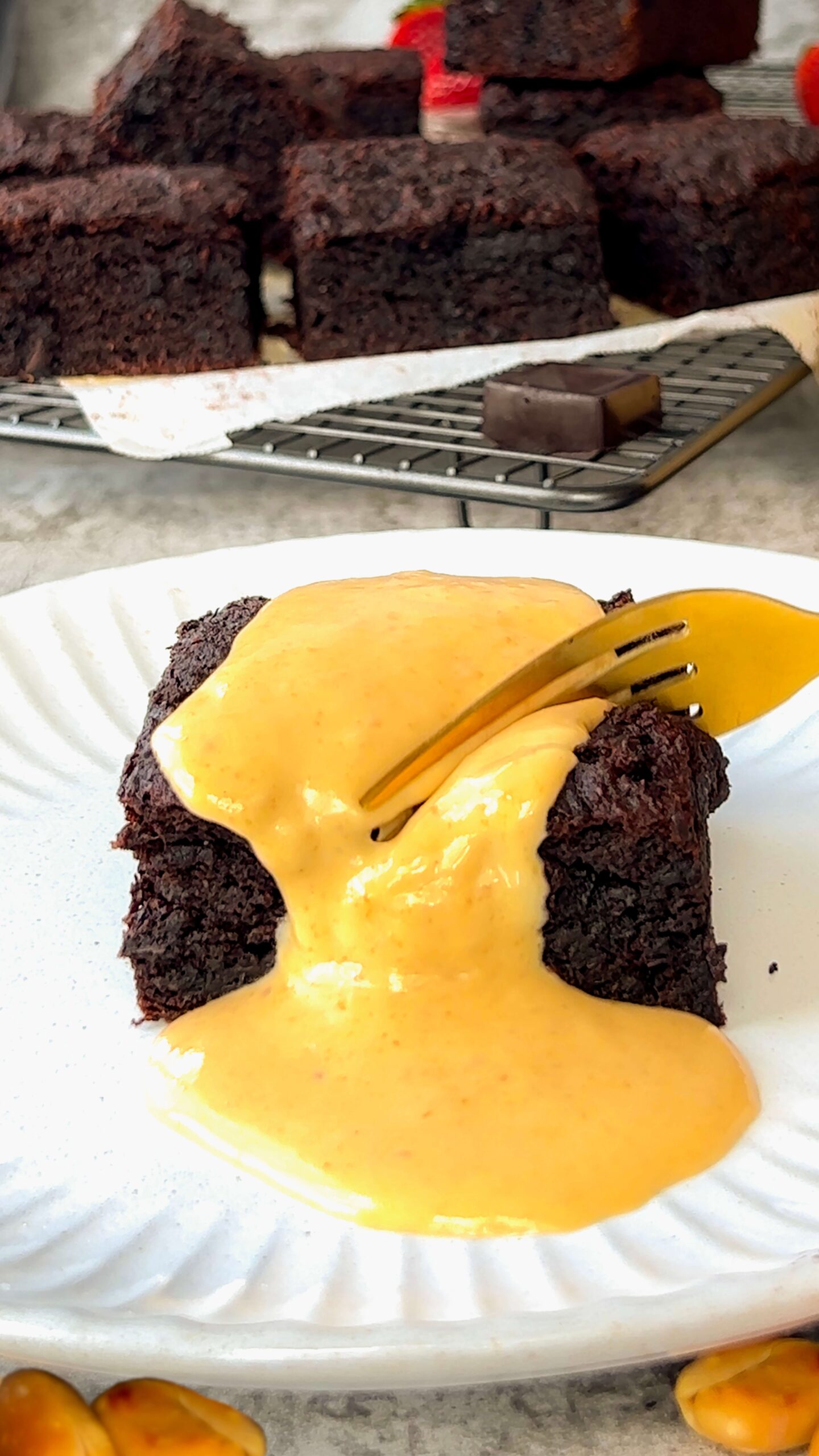 zoom in to two the texture of Creamy golden Peanut butter sauce being drizzled over a fudgy, banana brownie cake- for an extra indulgent