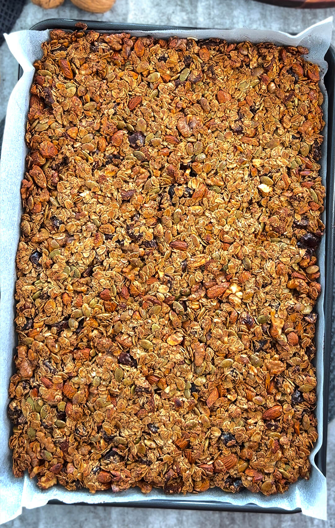 Freshly baked crunchy healthy granola clusters on a cooling tray- looks golden crunch 