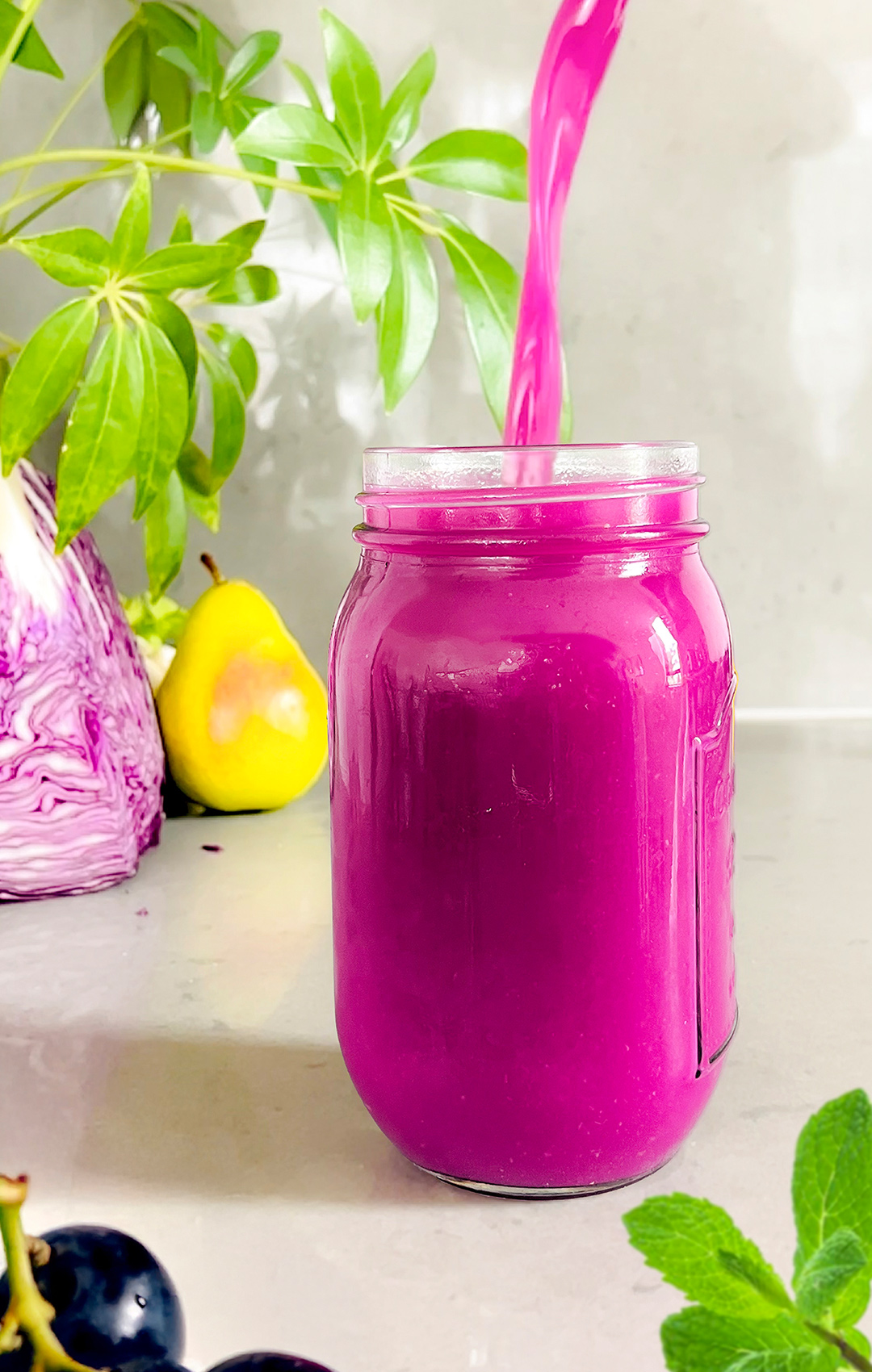 antioxidant-rich red cabbage juice with cucumber, pear, grapes, and mint – boosts immune function and heart health while supporting digestion