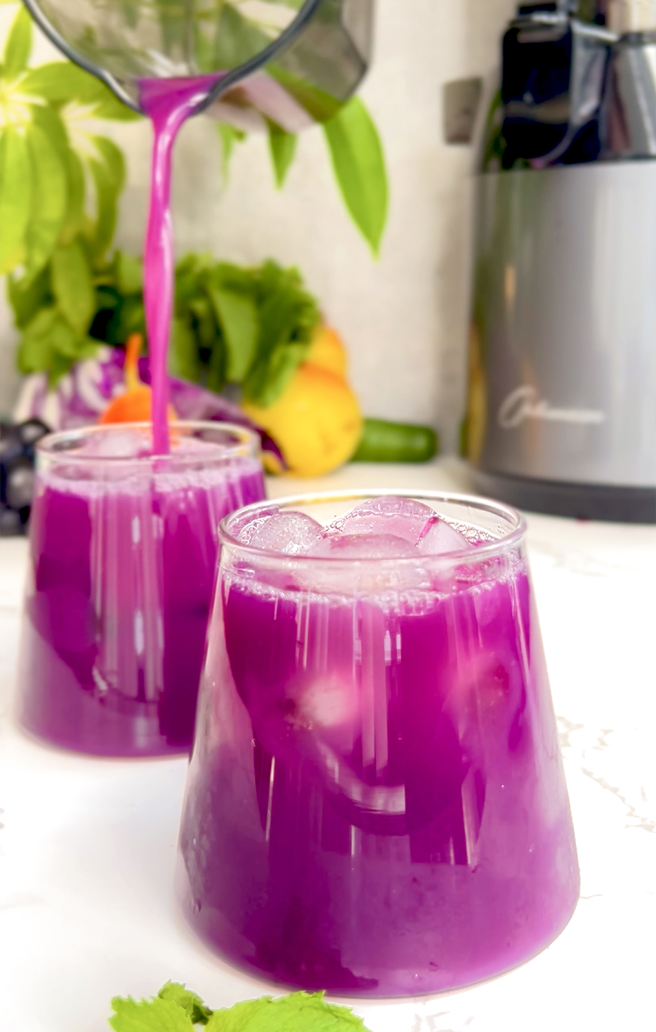 Anti-inflammatory purple juice made with red cabbage, pear, cucumber, grapes, and mint – rich in antioxidants to reduce inflammation, support detox, and improve skin health