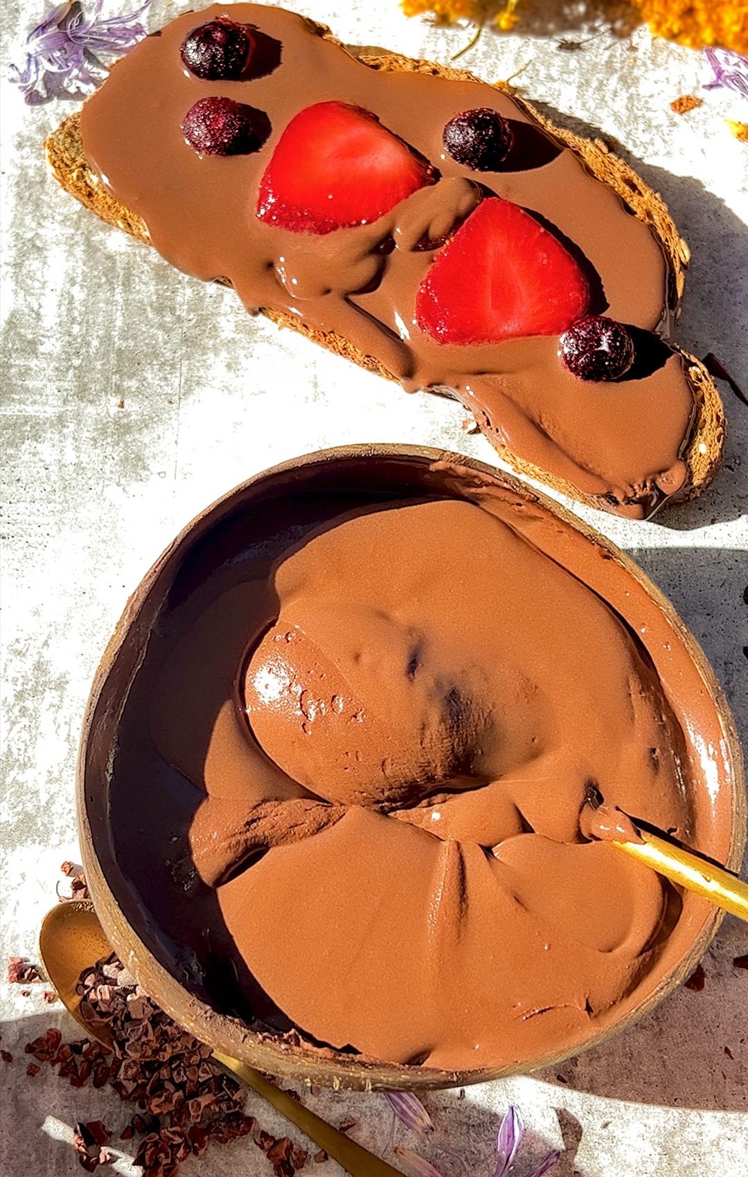 chocolate mousse in bowl next to toast topping chocolate mouse and strawberry 1