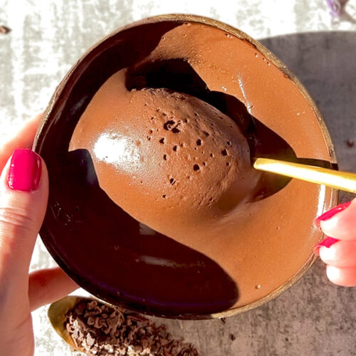 Silky chocolate cottage cheese mousse with a spoon resting on the bowl, showing its rich, decadent texture. A healthier, sugar-free, and keto-friendly dessert option.