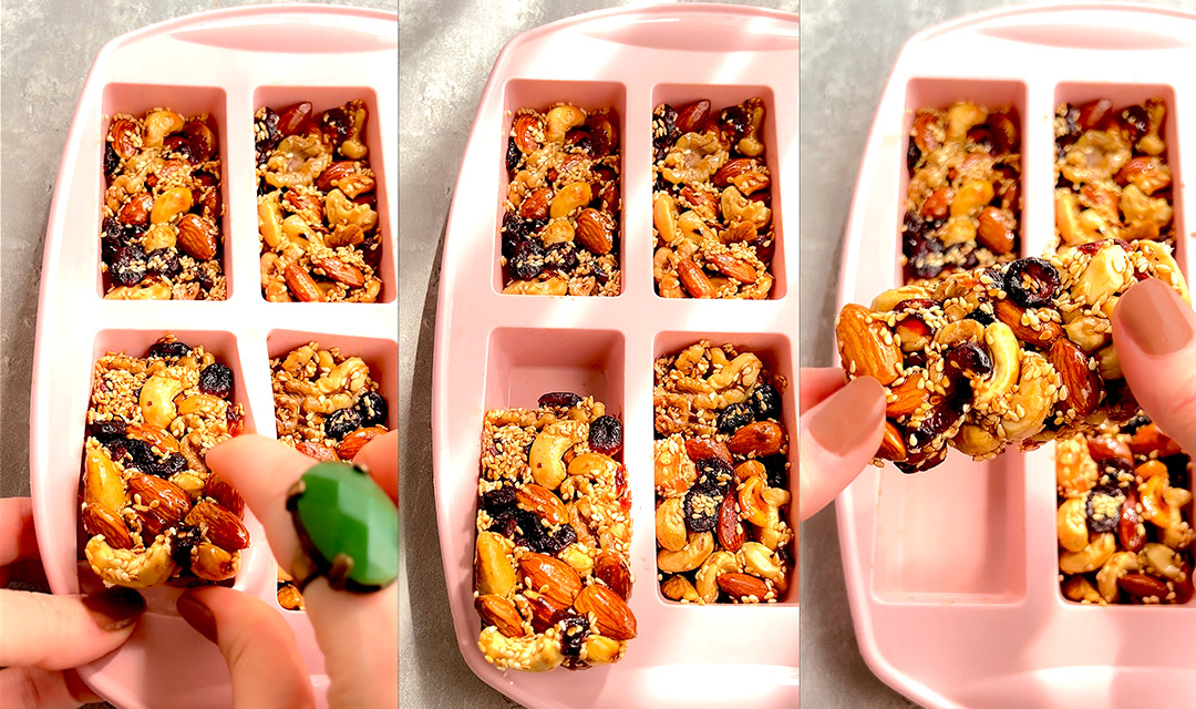 Final nut and seed bars removed from silicone moulds, shown close-up to reveal shiny surface and crunchy texture. Homemade, no-bake, protein-packed snack. Free from grains, oils, and refined sugars.