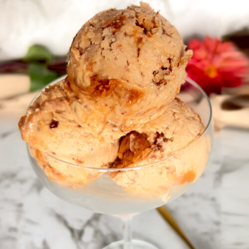 Scooping creamy ricotta peanut butter ice cream into a glass, showing its soft, no-churn texture.