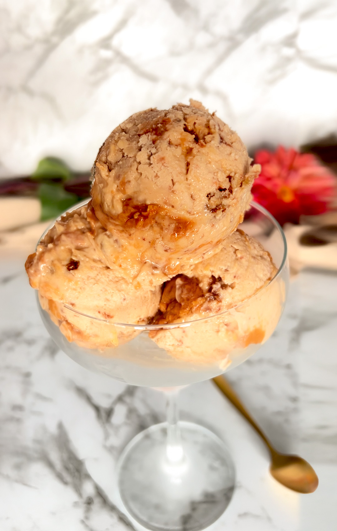 Scooping creamy ricotta peanut butter ice cream into a glass, showing its soft, no-churn texture.