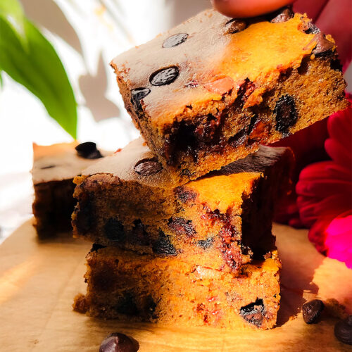 Overhead shot of healthy almond butter blondies with melty chocolate chips the perfect blend of gooey, chewy, and rich with golden, slightly crisp top. it's paleo, keto, sugar-free