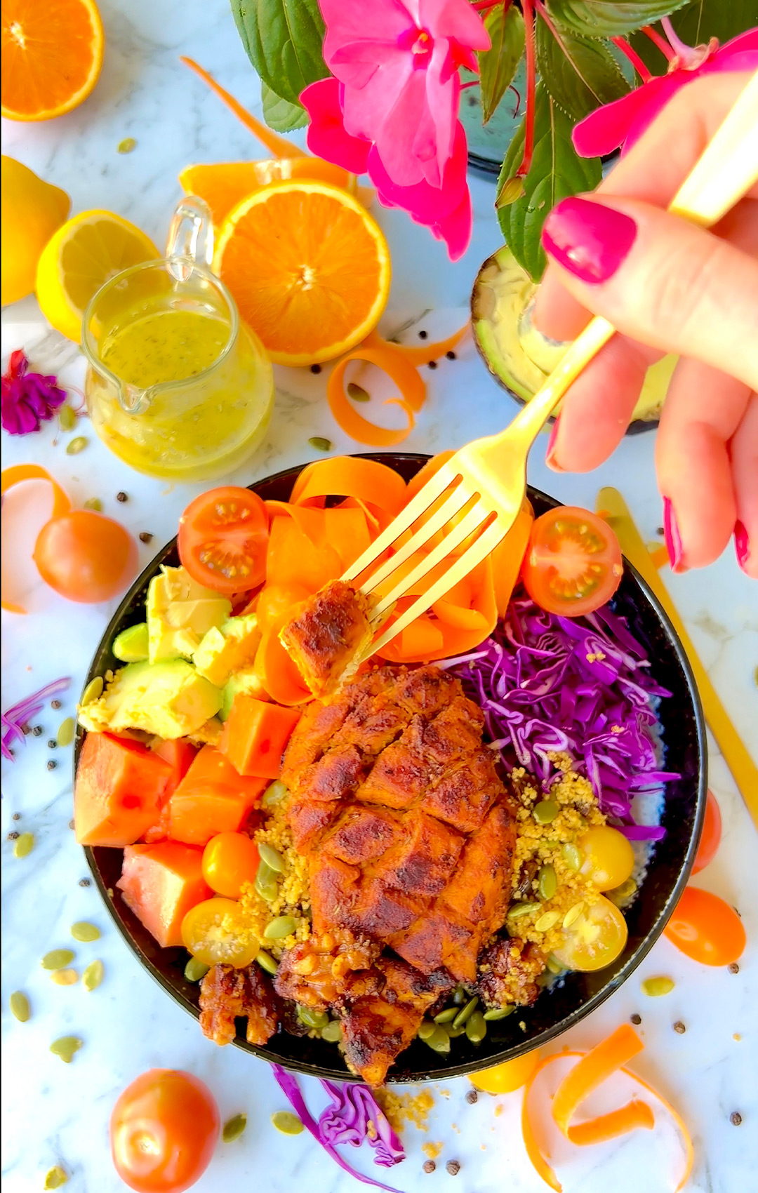 Diamond-cut marinated citrus chicken on a fork with salad bowl underneath. Juicy orange-colored chicken showing easy marinade absorption.