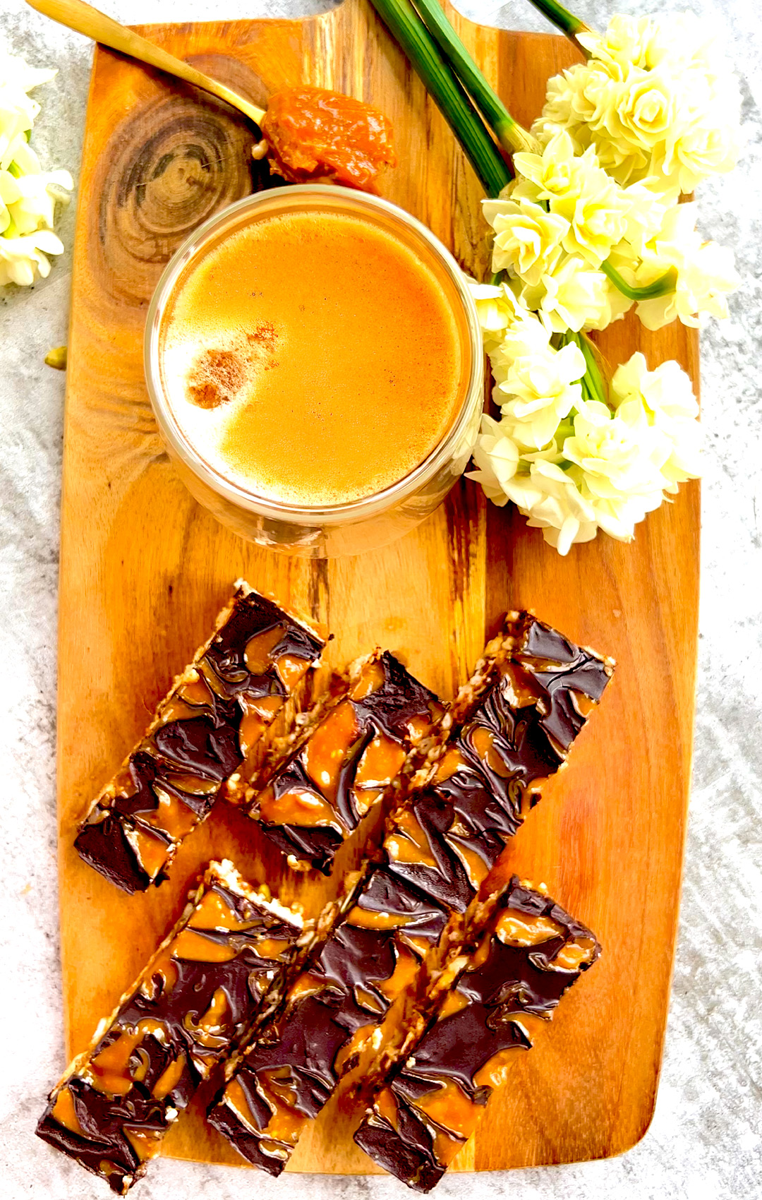 Slices of healthy Rice Cake Crunch Bars served on a wooden board alongside a cup of coffee—perfect for snacking- quick & easy to make at home- vegan, gf