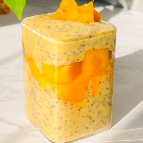 Creamy mango chia pudding layered with chopped mango in a glass jar, perfect for a healthy breakfast, Dairy-Free or tropical dessert