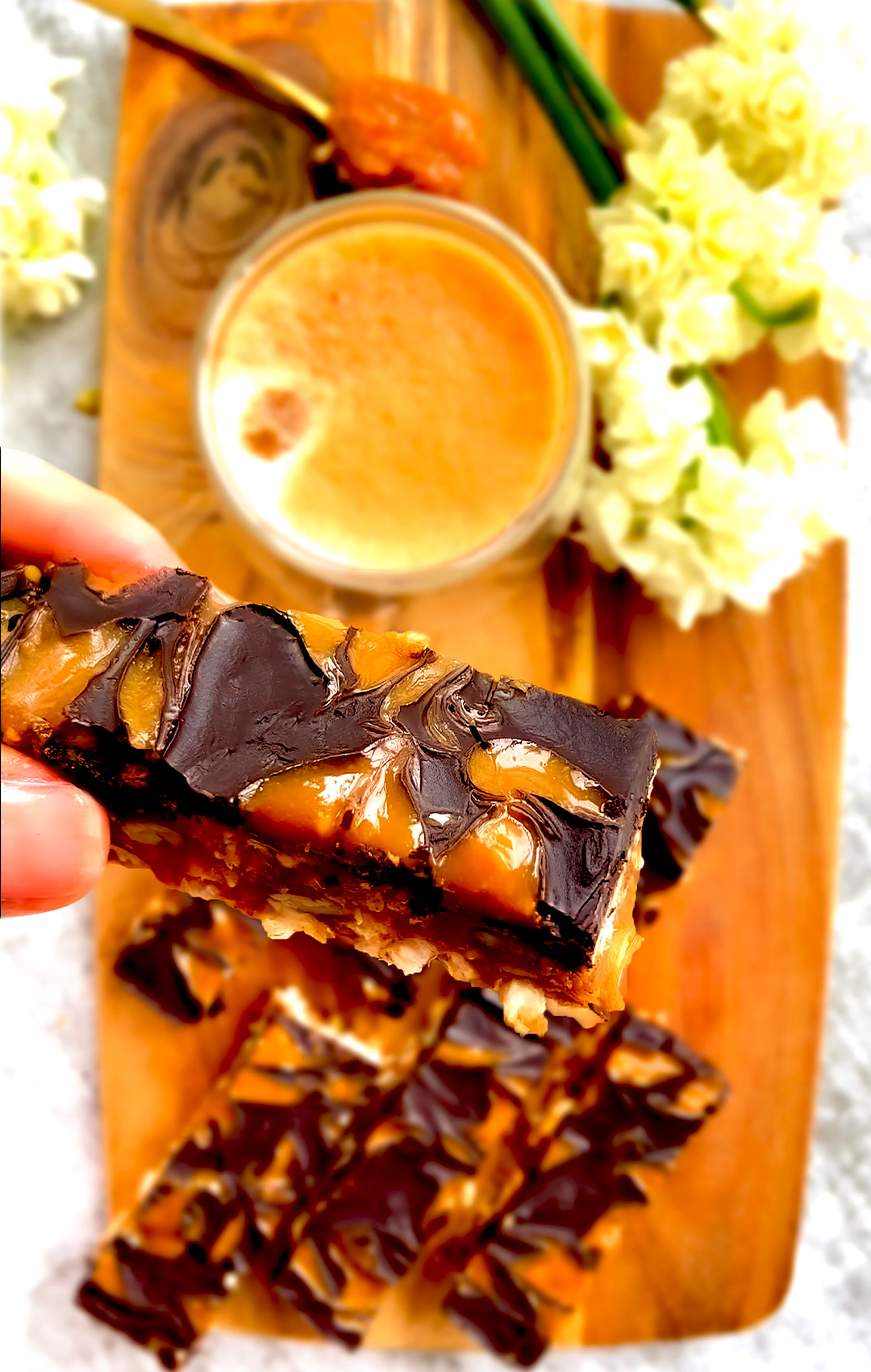 Close-up of Healthy No-Bake Rice Cake Crunch Bars featuring a rich swirl of peanut butter with a 3D effect on chocolate topping