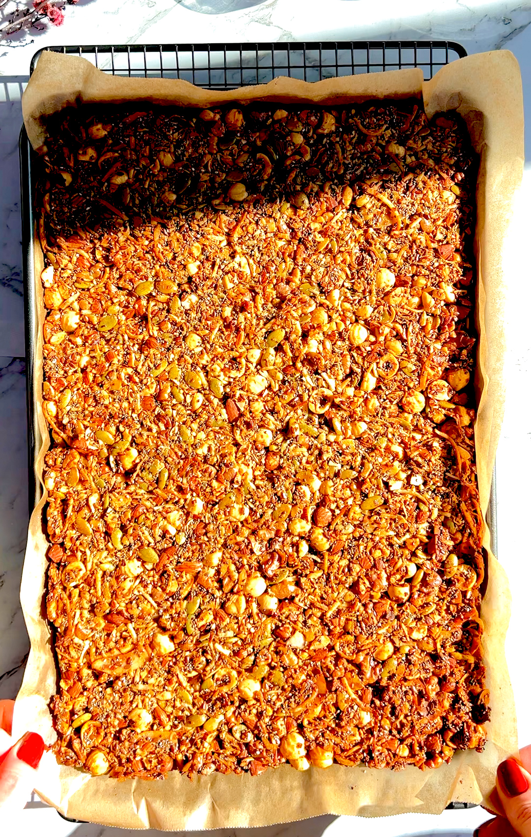 golden crispy sheet of Nutty Coconut Crunch Granola. Made with hazelnuts, almonds, walnuts, shredded coconut. it is High-protein, low-carb, paleo, keto, gluten-free, grain-free.