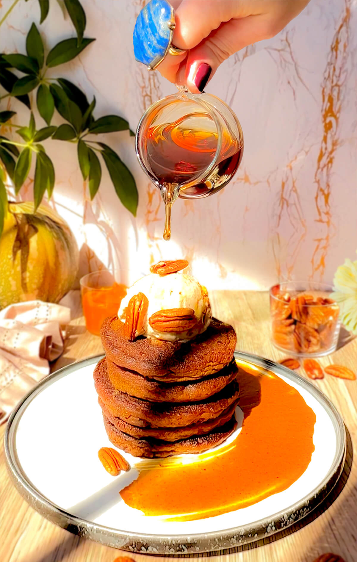 Cutting into a tall stack of soft, fluffy pumpkin pancakes topped with melting sugar-free vanilla ice cream and pecans, with golden syrup drizzling down. These keto pancakes are made with almond flour, coconut flour, lupin flour, and sweetened with monk fruit sweetener for a gluten-free, dairy-free, high-protein breakfast.
