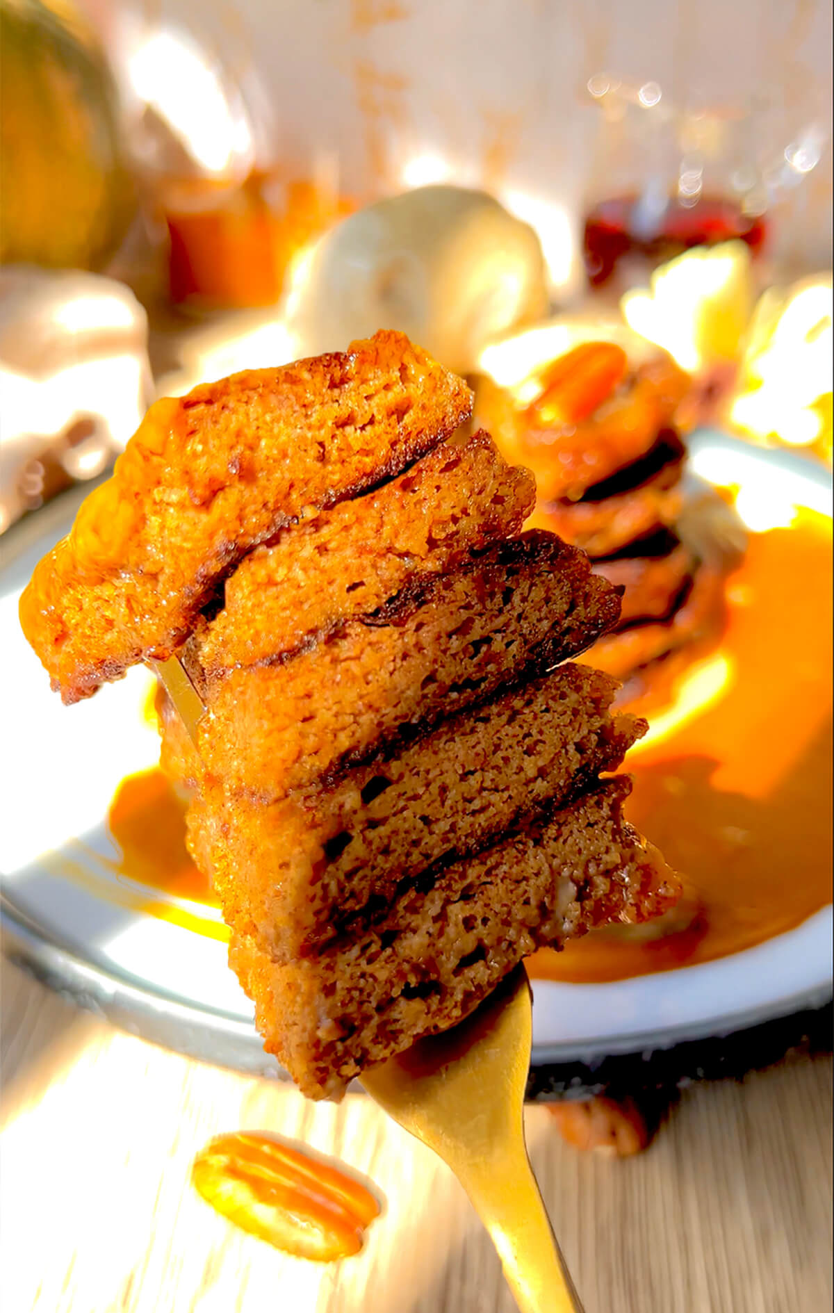 Close-up of a fork holding a slice of soft and fluffy keto pumpkin pancake, highlighting the moist, protein-rich texture. Made with almond flour, lupin flour, and monk fruit sweetener, this sugar-free, gluten-free breakfast is perfect for low-carb and high-protein diets.