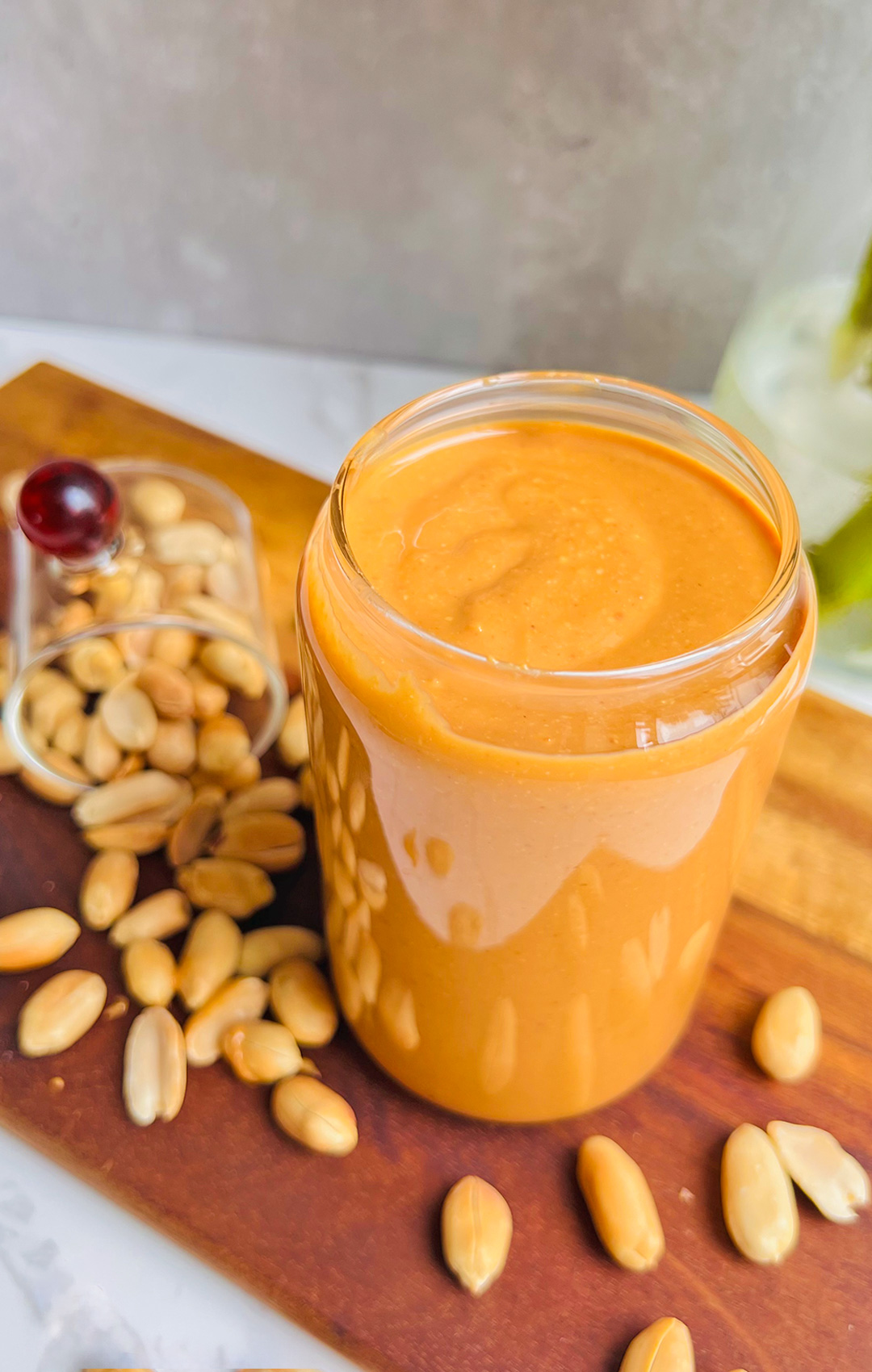 Close-up of glass filled with creamy golden Best Homemade Roasted Peanut Butter, made with roasted peanuts, pure nutty flavor, no oils, no preservatives, no sugar.