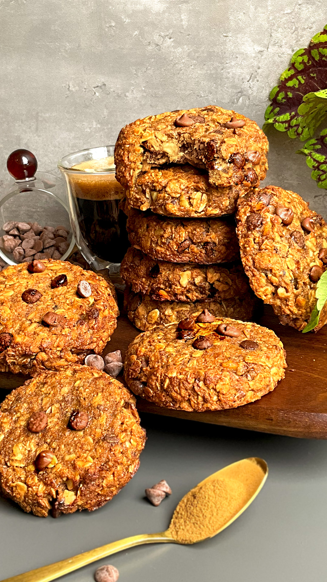 Stack of chewy banana tahini oatmeal cookies with walnuts and chocolate chips, a quick and easy 15 minute healthier cookie option served with coffee