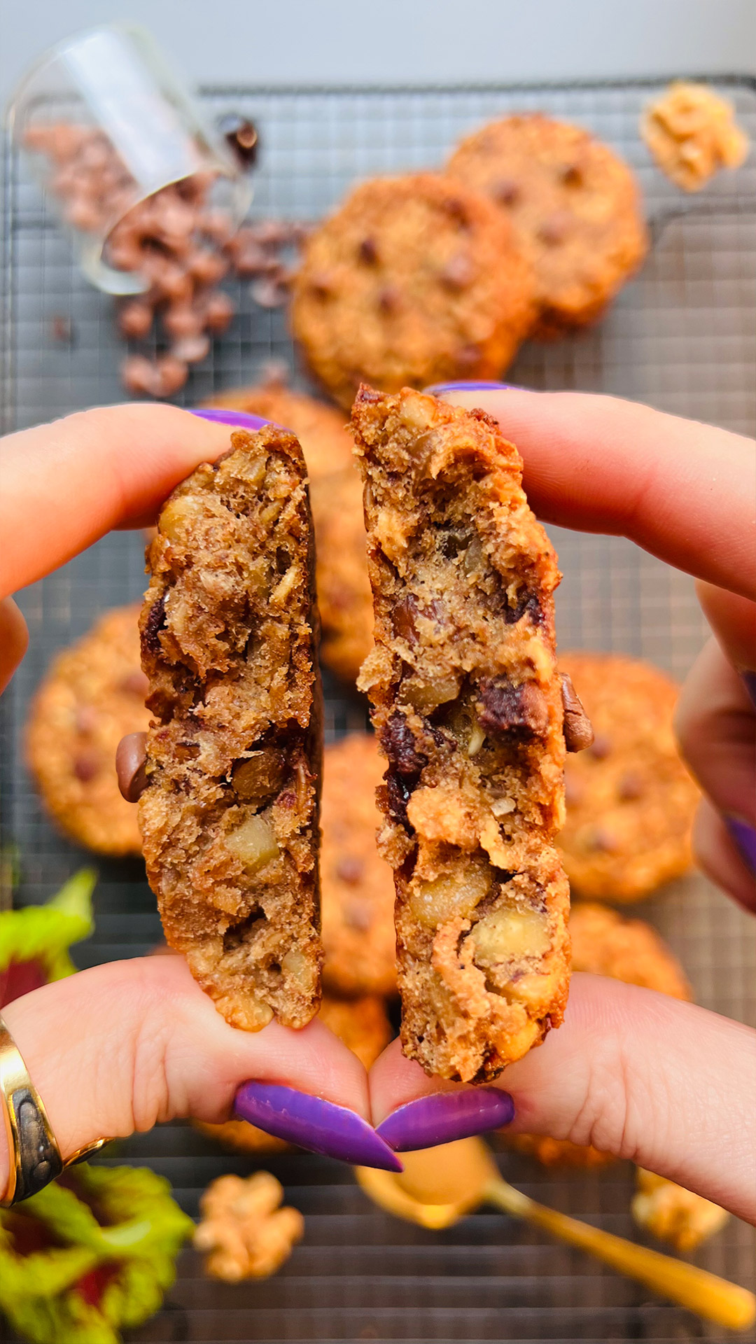 Inside of chewy banana oatmeal cookie showing gooey chocolate chips and walnuts, quick and easy healthy cookie recipe