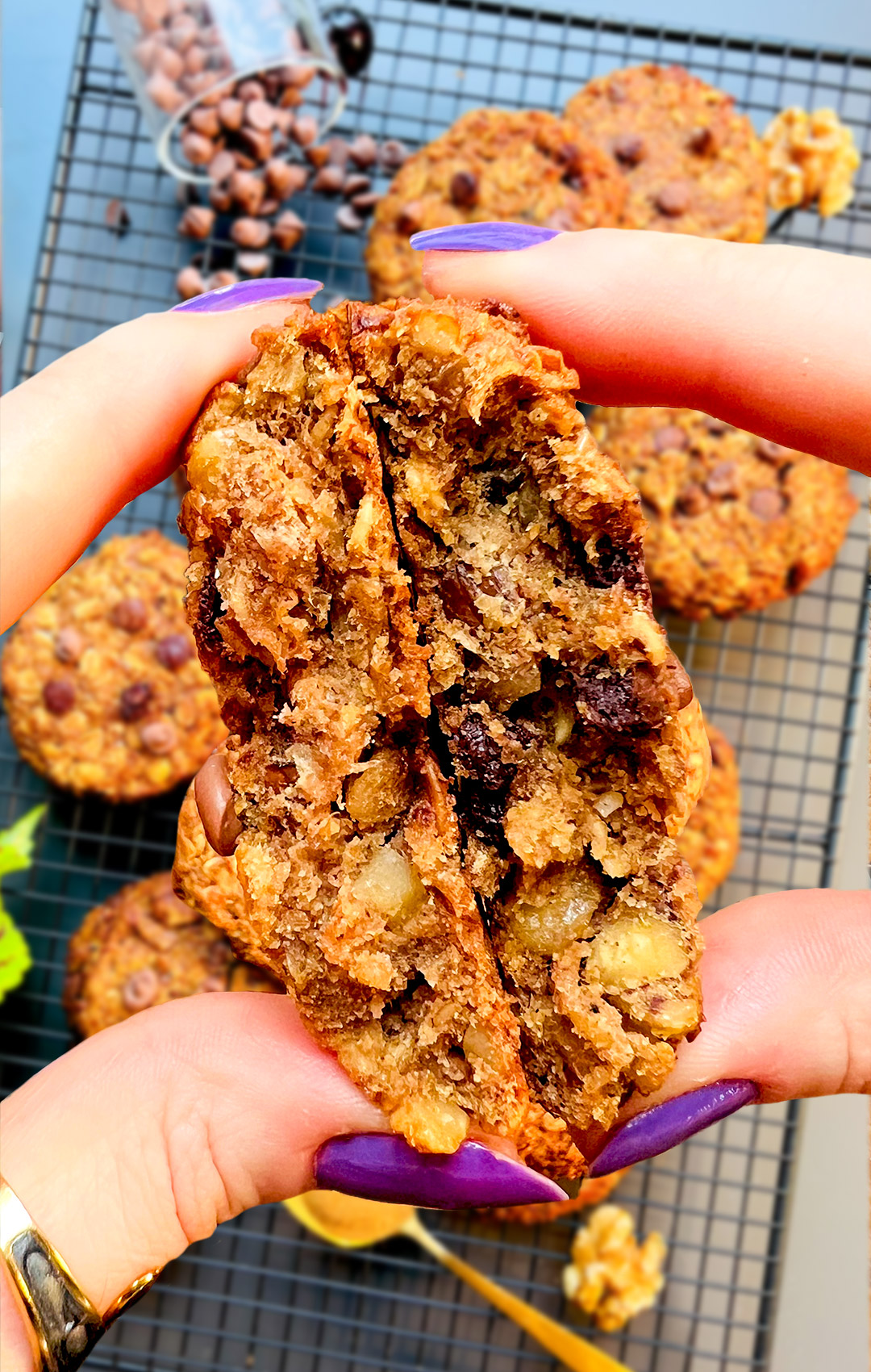 zoom in to Gooey banana tahini oatmeal breakfast that cute to half and show the texture . cookie packed with chocolate chips and walnuts, a healthier option refined sugar free cookie