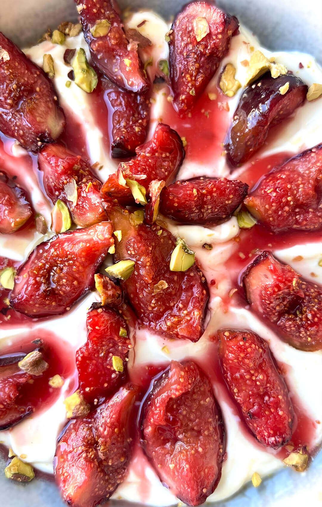 Mouthwatering Honey Roasted Figs over the Yogurt Bowl. Juicy figs are gently caramelised with honey, cinnamon, rosemary, cinnamon and lemon, served over creamy yogurt bowl with a touch of zest and crunchy pistachios. Quick and easy healthy desert or snack option.