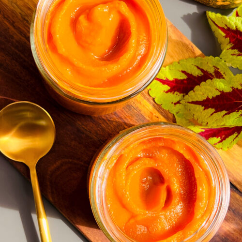 Close up of homemade pumpkin purée in glass jars showing silky smooth, thick and creamy texture. Freshly baked or cooked pumpkin purée made without water. Healthy, refined sugar free, vegan, paleo, gluten free, and perfect for pies, cheesecakes, pancakes, and fall desserts.