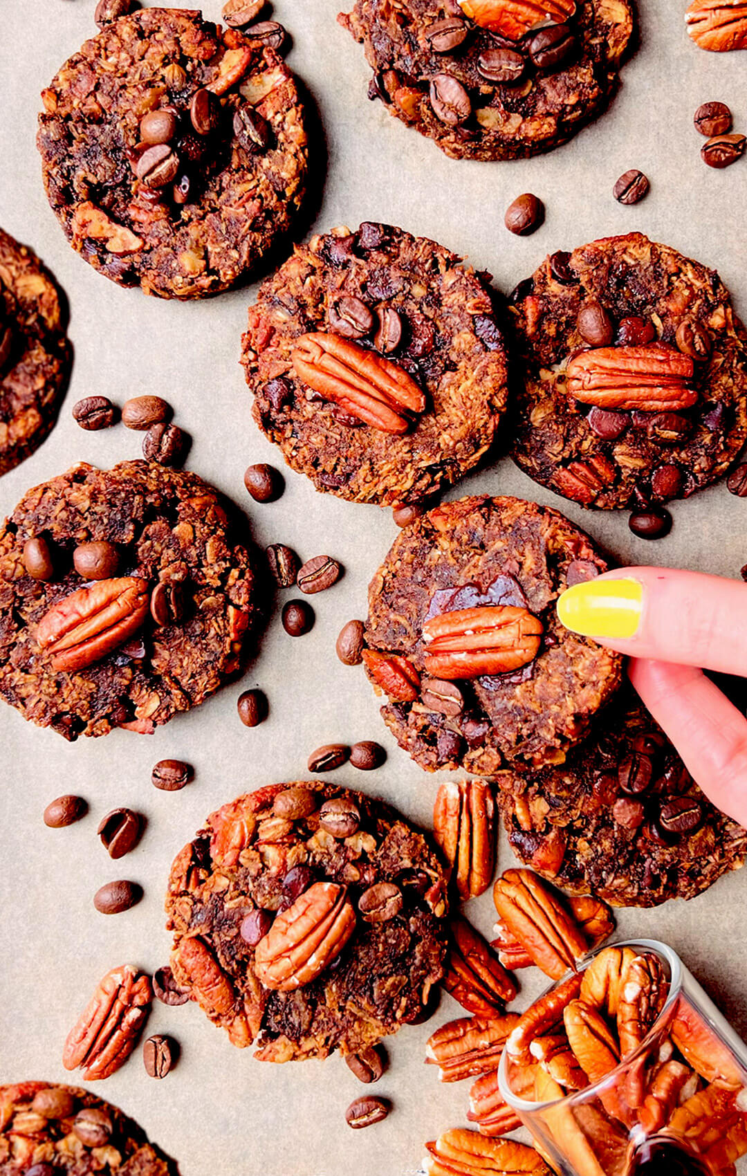 Zoom in Banana Oatmeal Cookies with Coffee and Pecans arranged on a tray and a cookie showing broken in half showing texture, gooey chewy centre. These healthy, refined sugar free oatmeal banana cookies perfect for healthy breakfast or an energy boosting snack also meal prep.