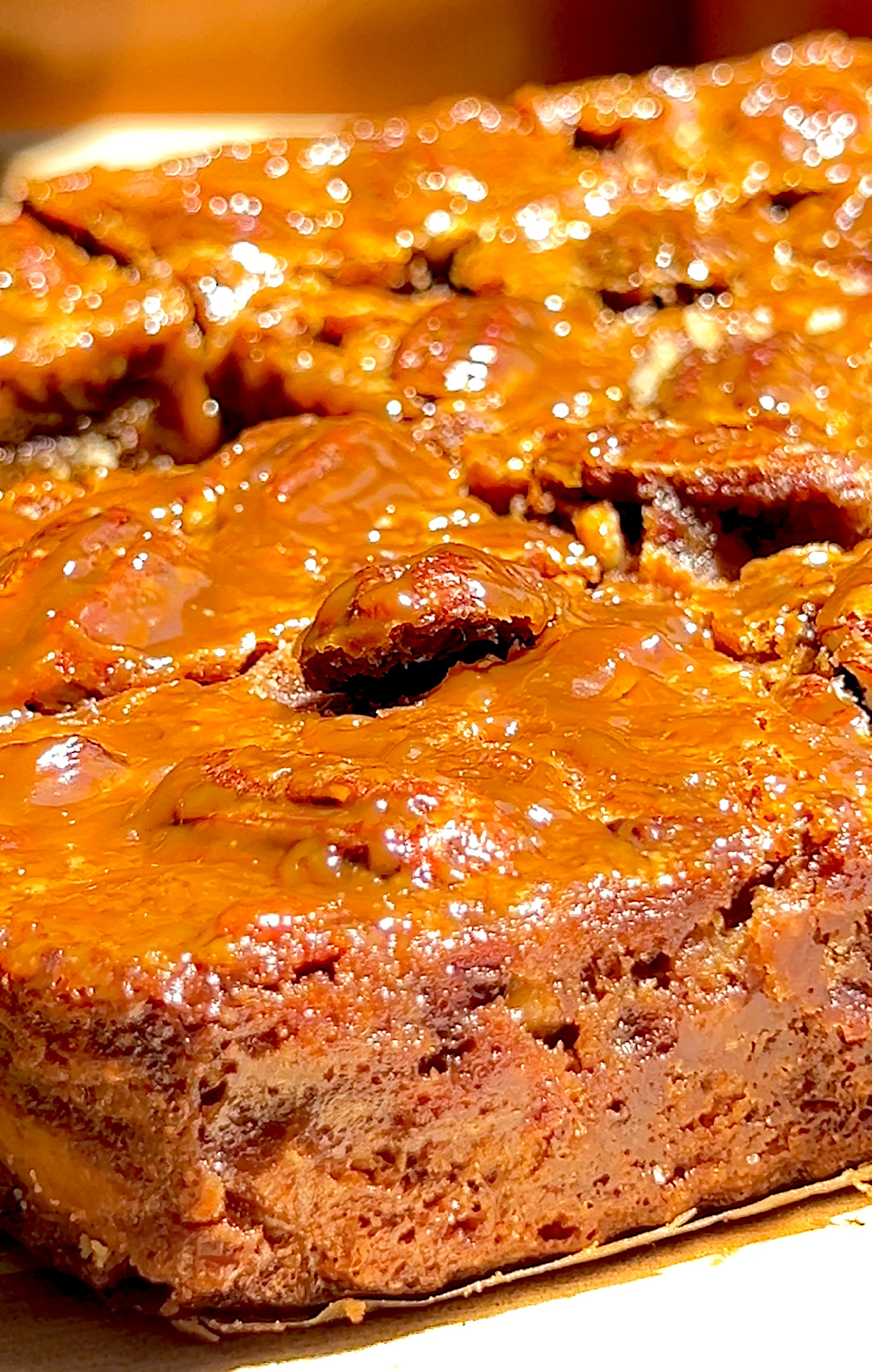 © Healthy Food by Annie – All rights reserved. No reuse without permission. Side and top view of whole slab of healthy caramel pecan pie bars, thick glossy maple caramel pecan topping with chewy crispy edges and moist centre, golden almond flour crust, rich sweet salty nutty flavour, paleo, gluten free, grain free refined sugar free desser.