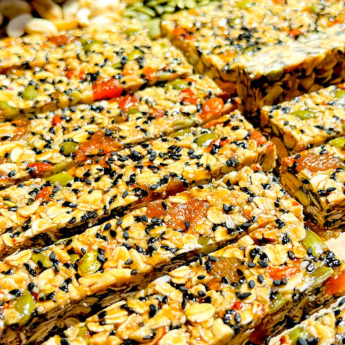 chewy honey and oat granola bars, combination of rich tahini and honey, creating a soft caramel like taste with a delicate hint of rosewater and cardamom, also every bite is filled with little pops of sweet apricot, crunchy pumpkin seeds, nutty almonds and black sesame, gluten free quick and easy homemade snack
