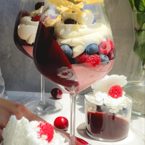 This image captures the signature moment of cracking the delicate white chocolate lace before digging into the sugar free trifle. Underneath are creamy layers, fresh berries, and pomegranate jelly, silky flummery layer. A playful, elegant, and satisfying dessert made without refined sugar and perfect for festive tables. its Low carb, keto, gluten free and sugar free.
