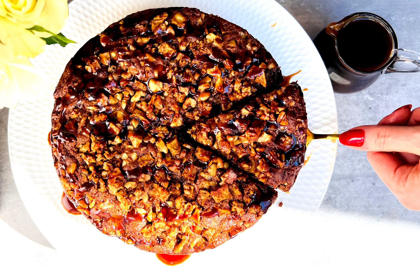 Overhead view of apple pudding cake and a served slice with caramel drizzle, showcasing caramelise crumb apple walnut topping. Refined sugar-free, healthy, gluten-free and paleo-friendly dessert.