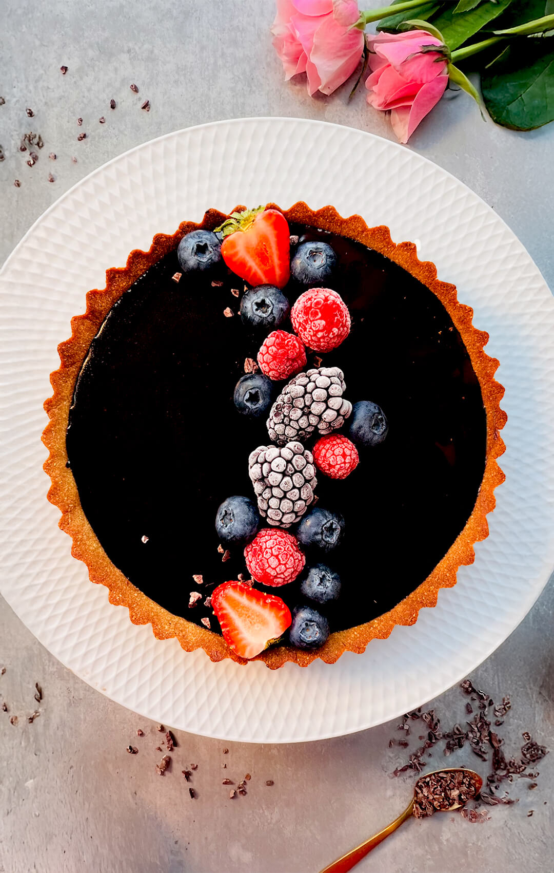 Finished chocolate tart made with a keto tart crust using almond flour, coconut flour, and monkfruit sweetener. This healthy, gluten-free tart crust is crisp yet tender, sugar-free, healthy and filled with a smooth no-bake chocolate filling, then topped with fresh berries.