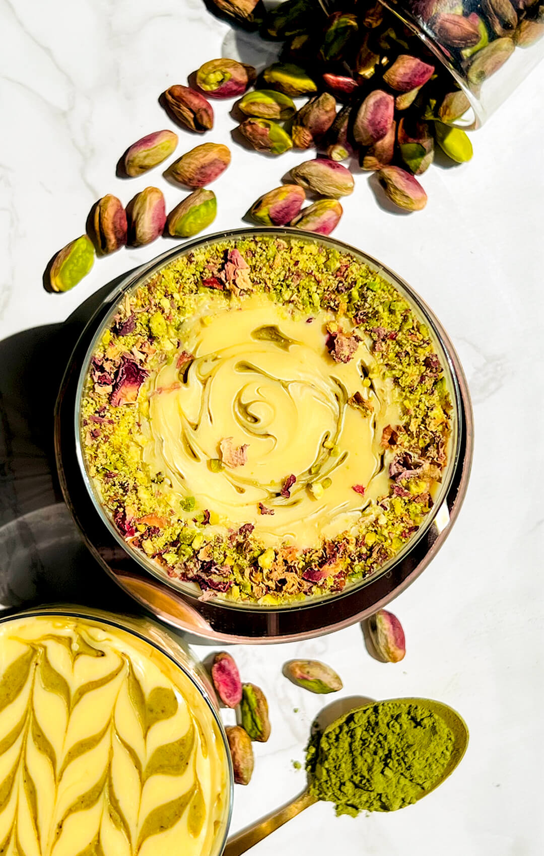 Top view of healthy pistachio cottage cheese pudding decorated with a white chocolate swirl, chopped pistachios, and rose petals. A gluten-free, low carb, high protein dessert made with simple ingredients and no artificial colours.