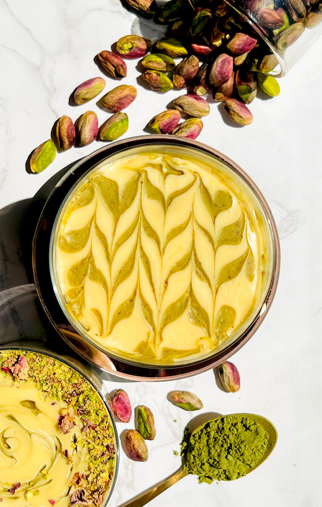 Beautifully decorated pistachio cottage cheese pudding with an elegant swirl pattern. This refined sugar-free dessert has a thick, creamy texture and naturally green colour, made by blending pistachios, cottage cheese, matcha, and rosewater.