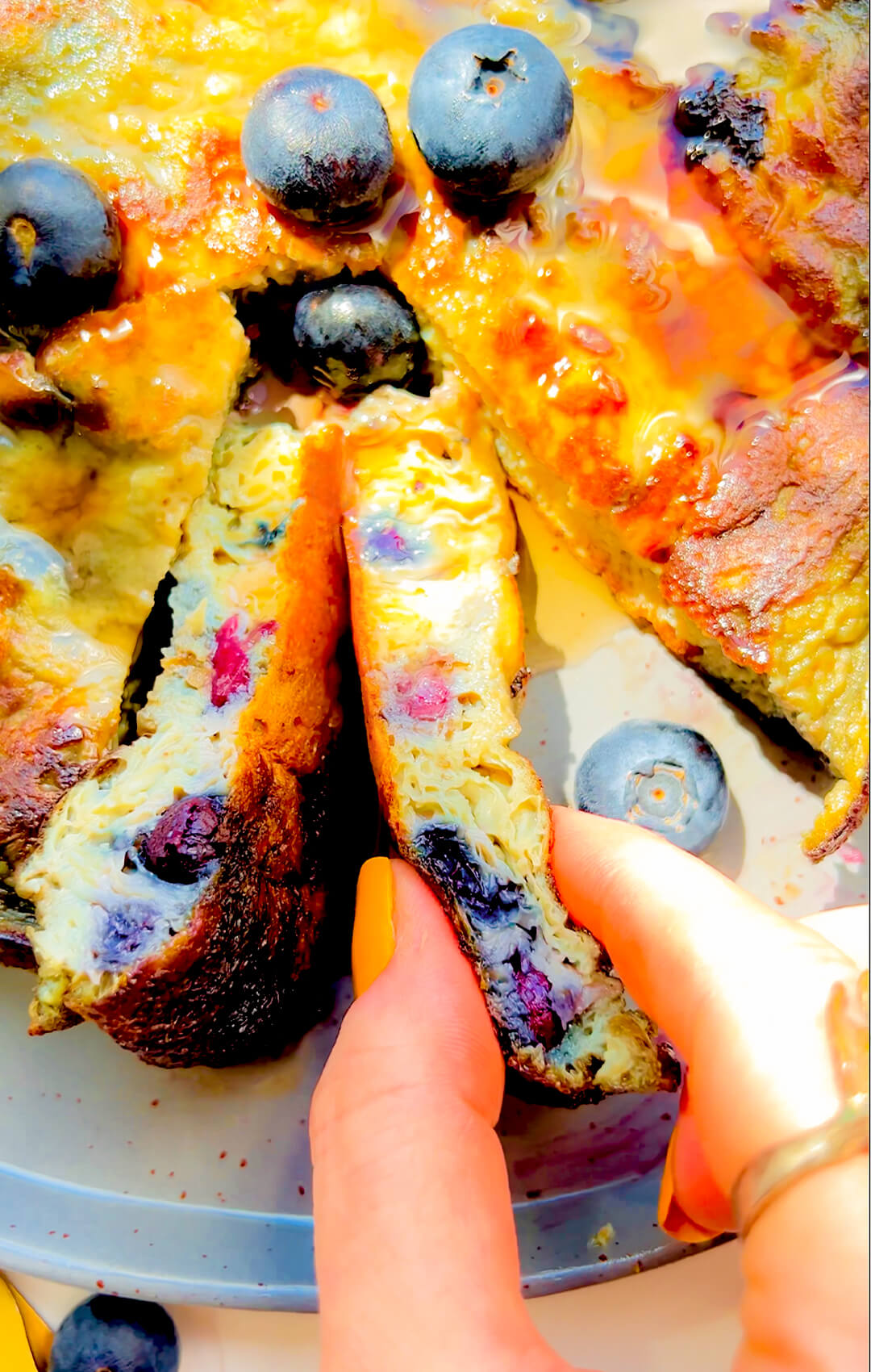 Close-up of 10-Min fluffy blueberry omelet texture showing soft airy and fluffy centre with blueberries and caramelised edges, flourless, keto, gluten-free, low-carb and sugar-free breakfast or brunch.