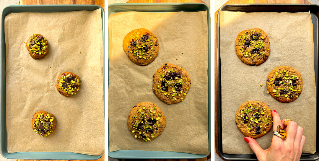 Pistachio chocolate chunk cookies baking on parchment-lined tray, showing thick dough rounds topped with pistachios and dark chocolate chunks.