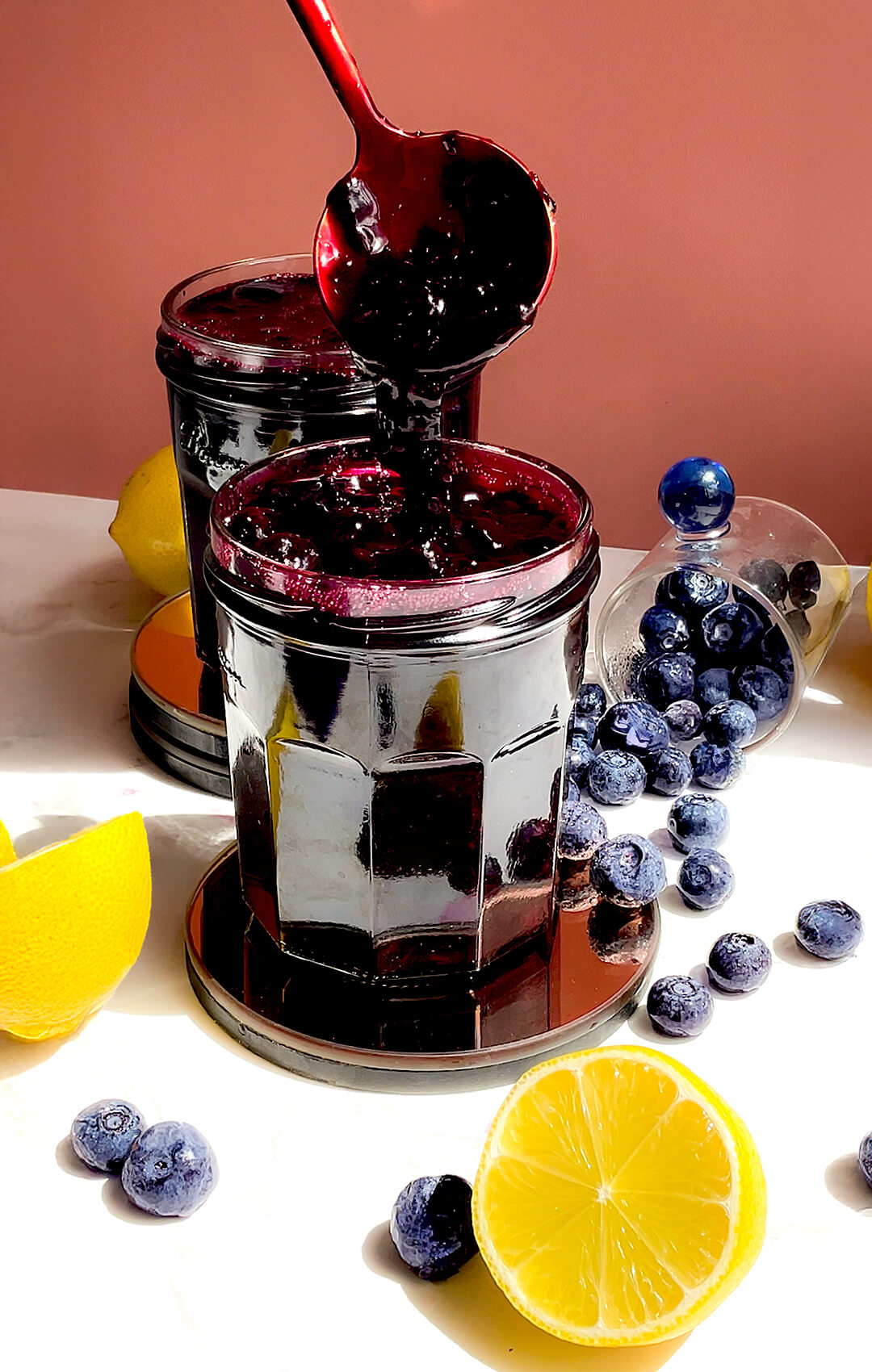 © 2026 Healthy Food by Annie. All rights reserved. Spoon pouring thick blueberry sauce into a jar to Showing the consistency, refined sugar-free and ready in 15 minutes.