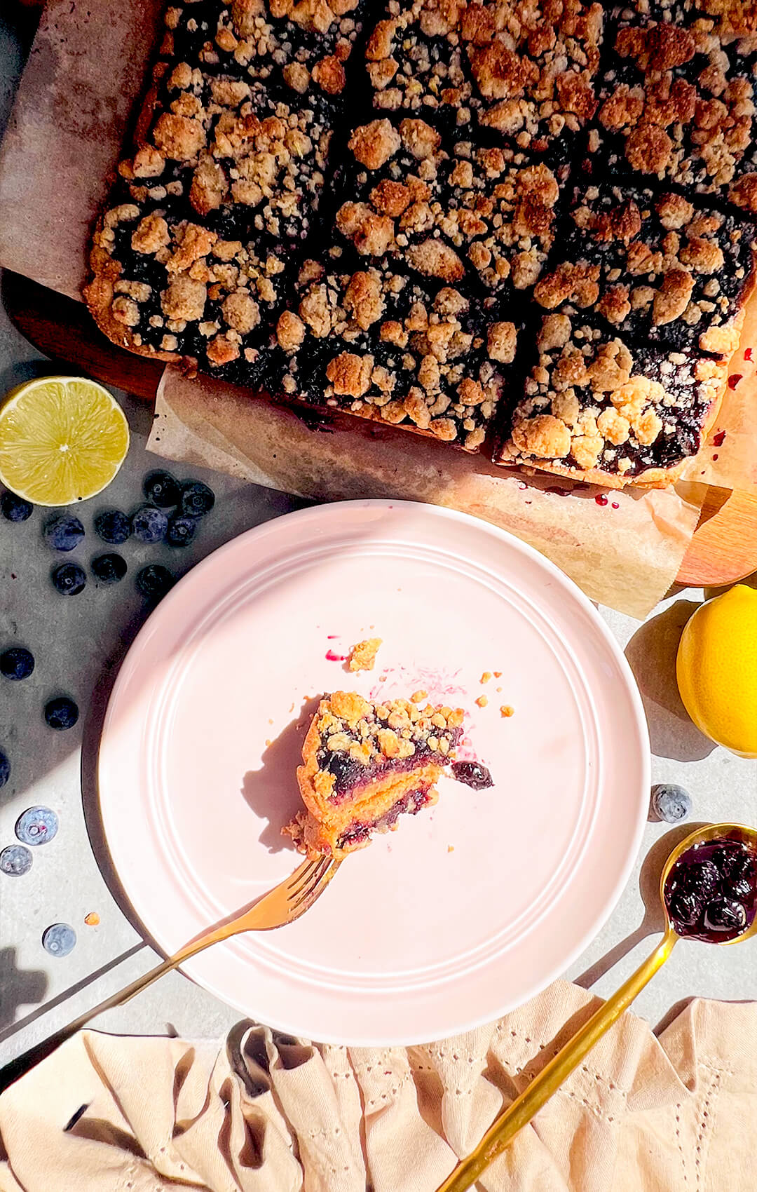 Served blueberry crumble bar with a thick glossy homemade blueberry sauce centre that tastes sweet and tangy, topped with a golden buttery crumble and a soft buttery almond flour base, wholesome, refined sugar-free, gluten-free, paleo treat perfect with coffee or as dessert also meal prep.