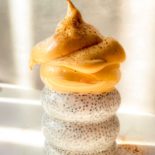 Honey Dalgona Coffee Chia Pudding in a glass with creamy vanilla chia pudding and a thick velvety whipped honey coffee topping, dusted with cinnamon, a healthy mix of morning coffee and breakfast that is paleo, gluten-free, dairy-free, refined sugar-free, quick and easy to make in 5 minutes, and perfect for breakfast or an afternoon treat.