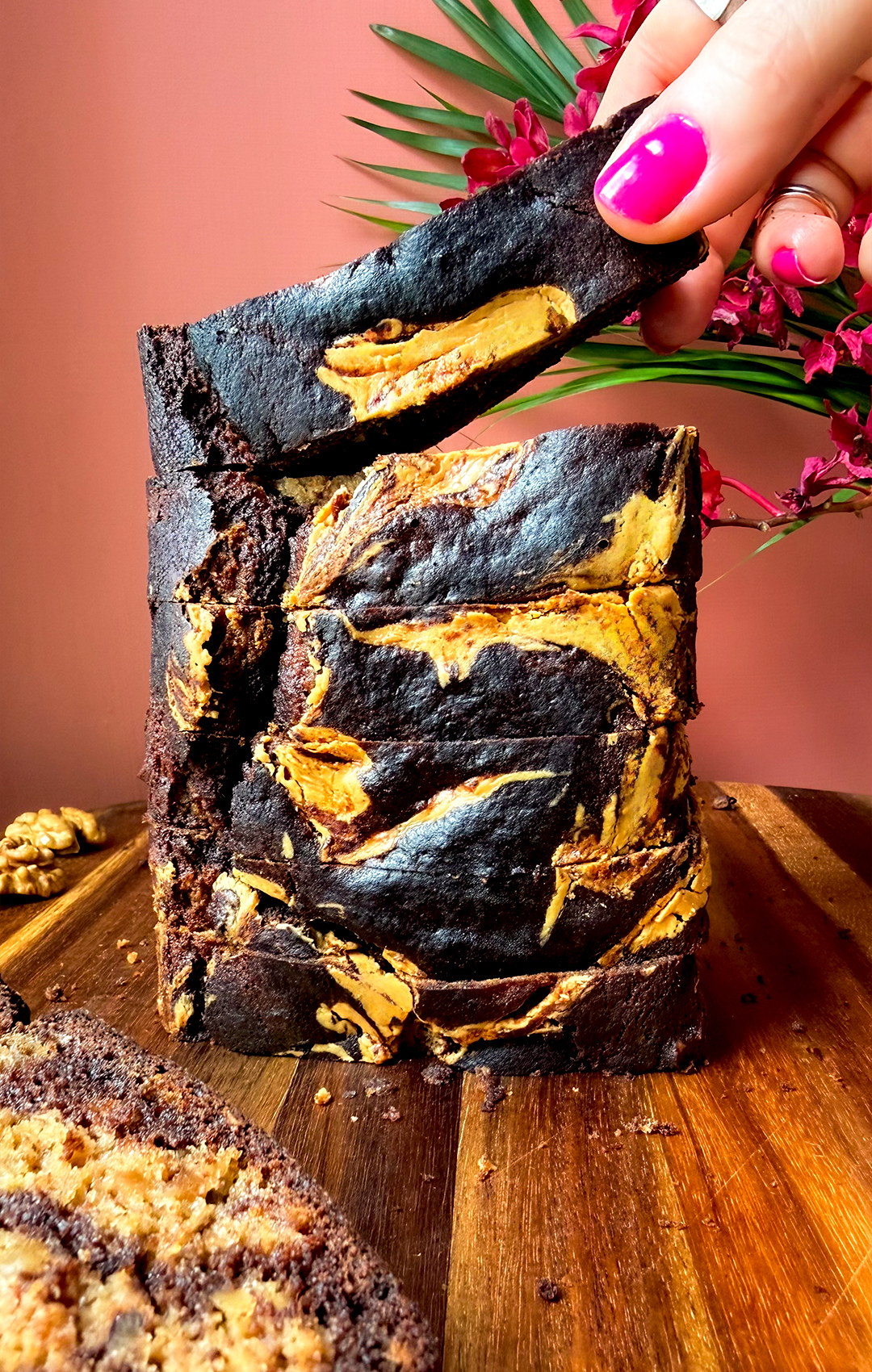 Stacked slices of healthy marble banana bread with rich dark chocolate swirls and golden peanut butter ripple, showing a soft, moist, fluffy crumb with crunchy walnut pieces, gluten-free and made with wholesome ingredients.