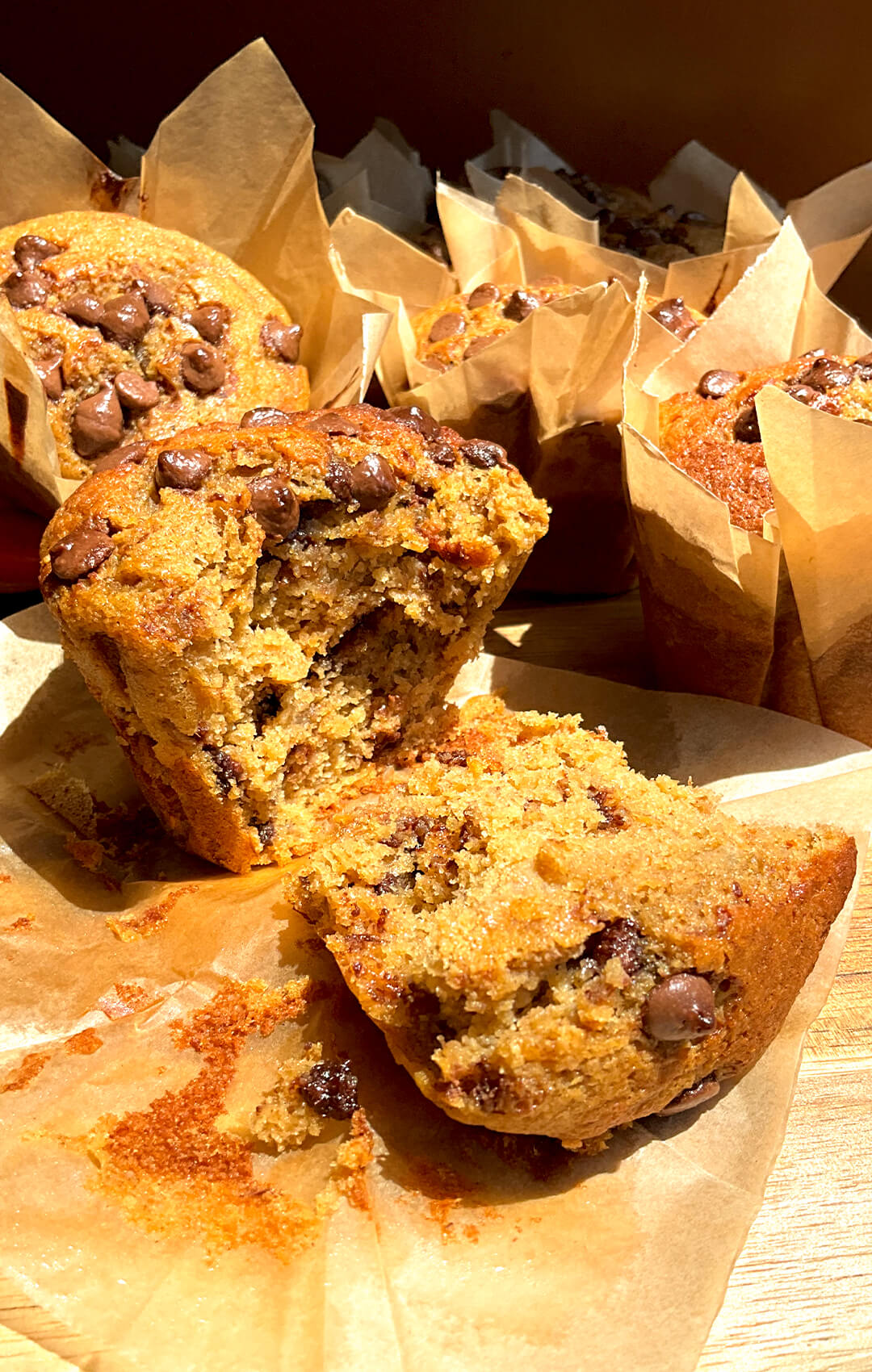 Sliced of Banana Oat Chocolate Chip Muffin showing moist tender crumb and melted chocolate pockets, banana bread flavour in muffin form, quick and easy high protein high fiber muffins with oat flour and lupin flour.