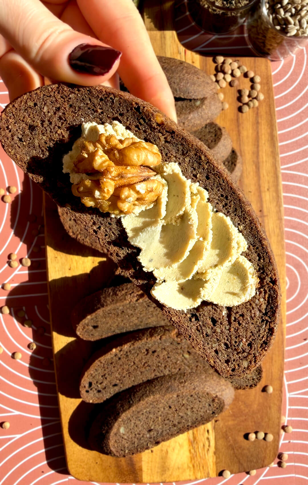 Rustic brown lentil bread topped with creamy spread and walnut, showing a soft chewy crumb and dark rye-style colour. This gluten-free, flourless bread is yeast-free, egg-free, high in fibre, protein-rich, hearty, satisfying, and perfect with savoury or sweet toppings without tasting like lentils.