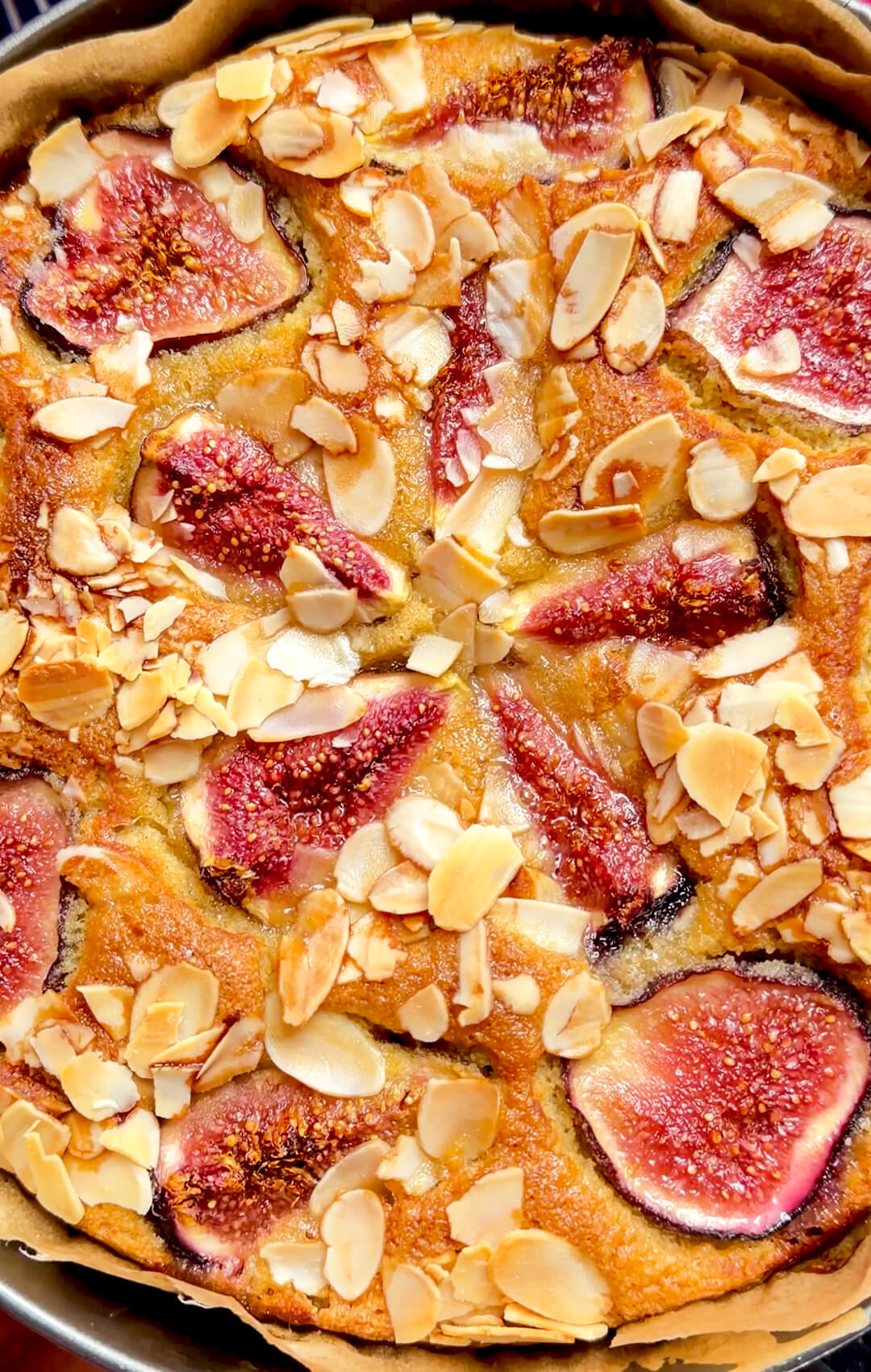 Close-up of the crunchy sliced almond topping on Fig Almond Olive Oil Cake with juicy roasted fresh figs and a golden almond flour cake. A healthy, guilt-free, gluten-free, keto-friendly and dairy-free dessert made with wholesome ingredients and a soft moist crumb.