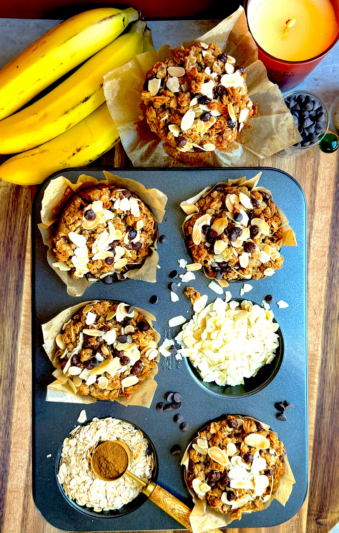 Healthy gluten-free banana bread crumble muffins in a muffin tray with ripe bananas, oats, sliced almonds, coconut sugar, and sugar-free chocolate chips. These soft, delicious, dairy-free banana muffins are refined sugar-free, naturally sweetened, easy to make at home, and perfect for breakfast, snacks, or meal prep.