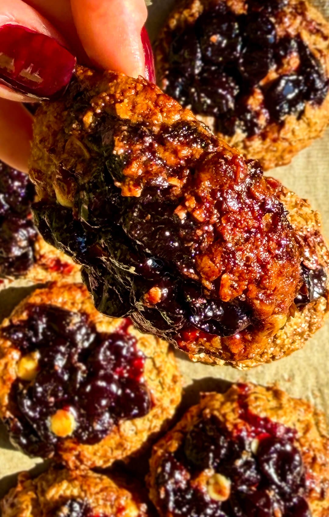 Golden peanut butter sour cherry oatmeal cookie with caramelized edges, glossy homemade cherry filling and sugar-free white chocolate chips, made with rolled oats, almond flour and wholesome gluten-free ingredients.