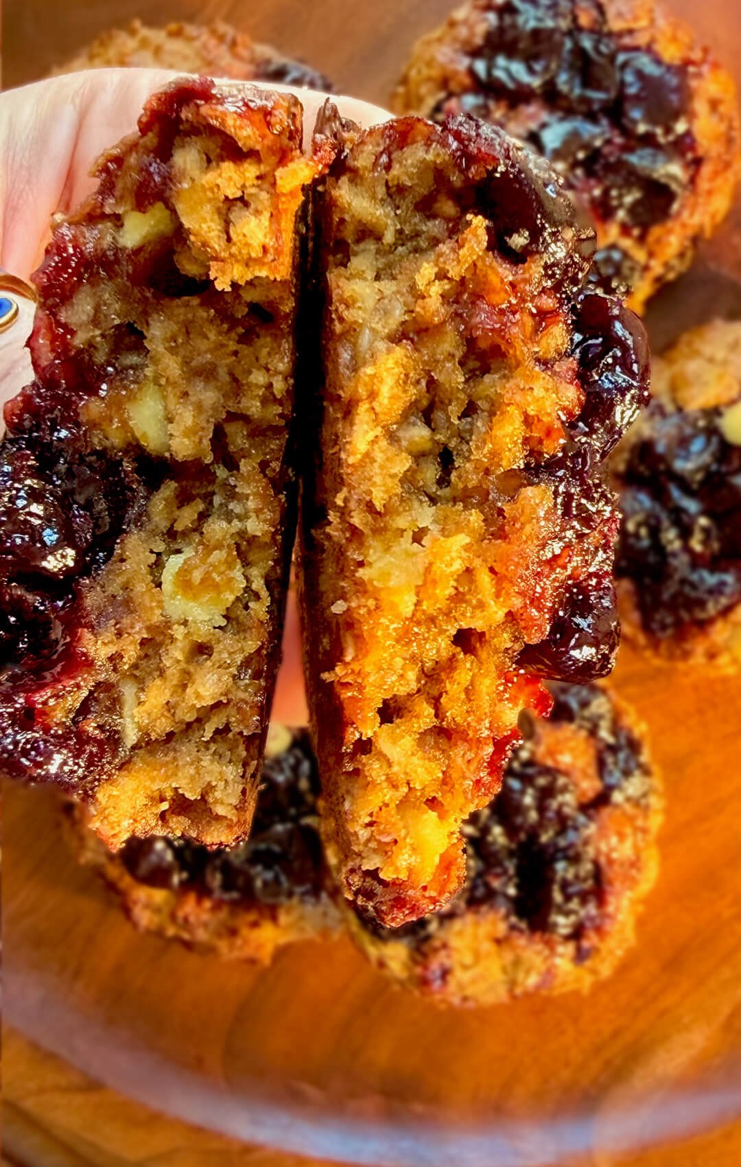 Broken sour cherry peanut butter oatmeal cookie showing a moist chewy center with rolled oats, almond flour, peanut butter, glossy cherry pockets and sugar-free white chocolate in a wholesome gluten-free cookie.