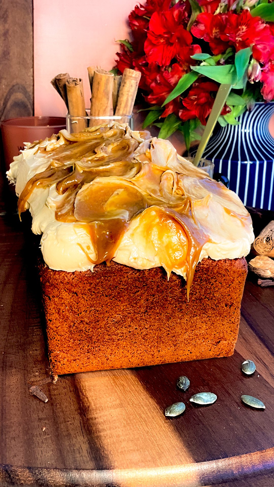 Whole healthy pumpkin bread topped with thick, silky peanut butter cream cheese frosting and glossy coconut caramel swirls. This easy gluten-free, refined sugar-free loaf is made with wholesome almond, oat, and lupin flours, coconut sugar, and brown monk fruit sweetener, with a sugar-free option.